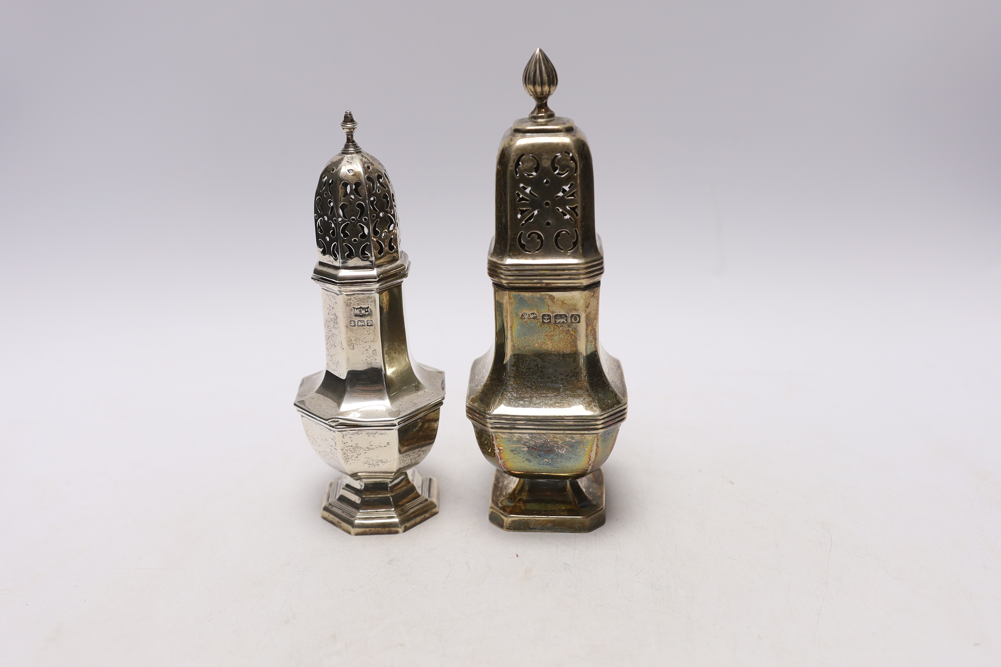 Two George V silver sugar casters, largest 18.4cm, 8.2oz.